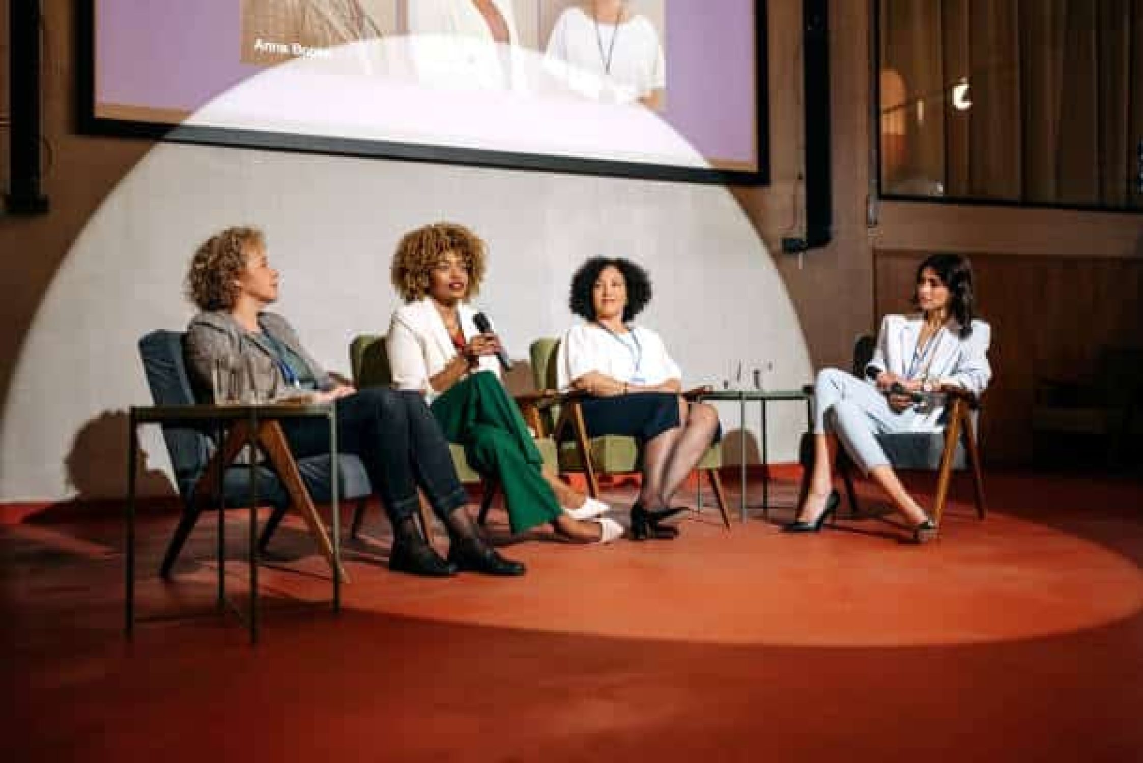 Female presenters having a speech in conference hall